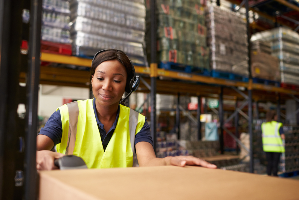 woman,using,a,barcode,reader,in,a,distribution,warehouse